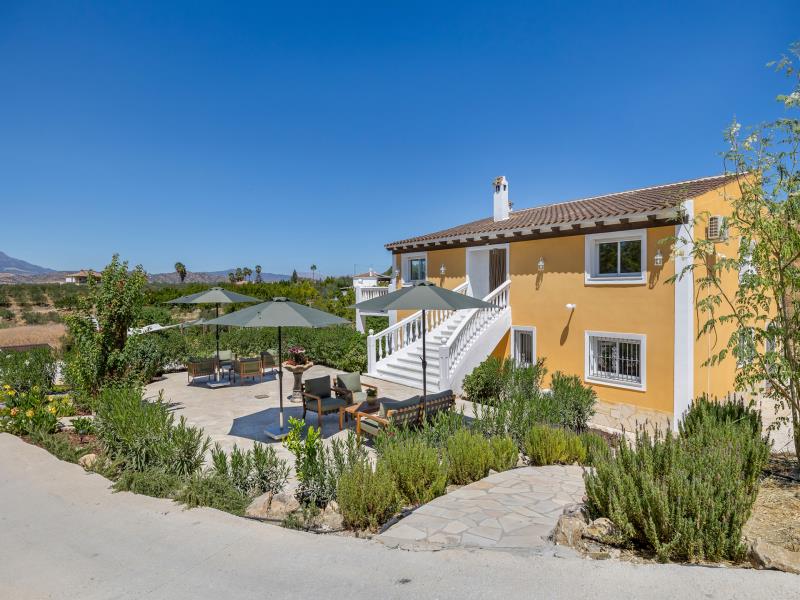 Ochre-yellow villa with double marble staircase and sunny terrace