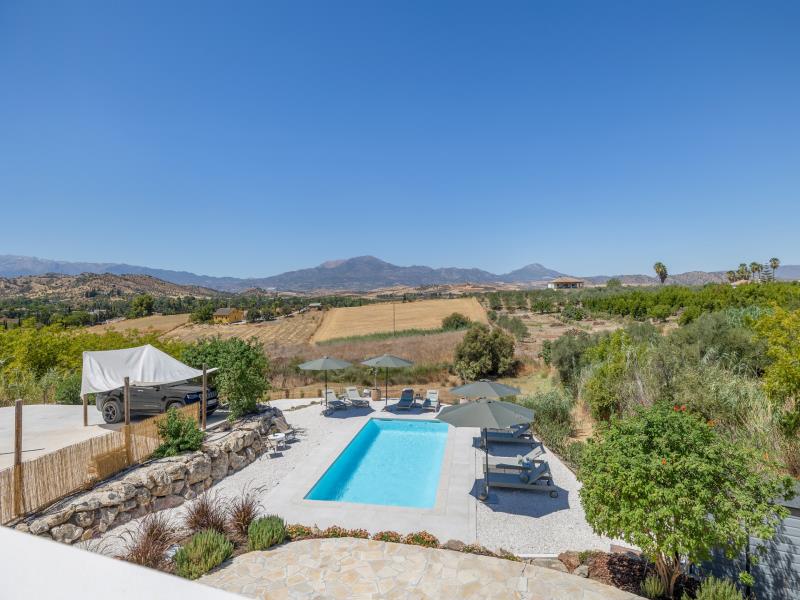View over the property with pool and sweeping mountain landscape