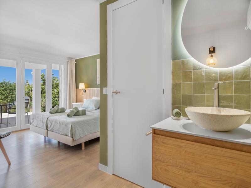 View from the bathroom through to room 2 with green tiling