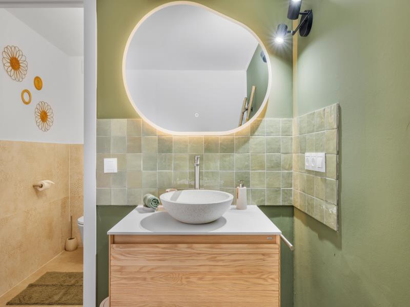 En-suite bathroom for room 3 with organically-shaped mirror